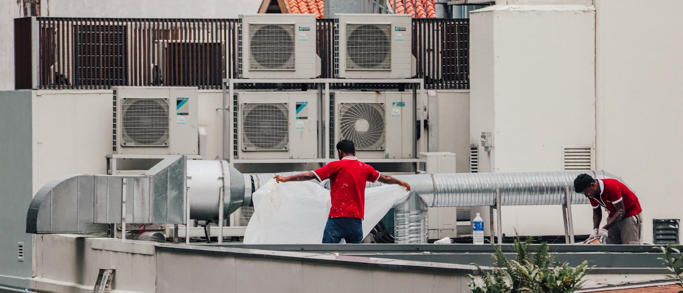 Technician servicing a wall-mounted split air conditioner