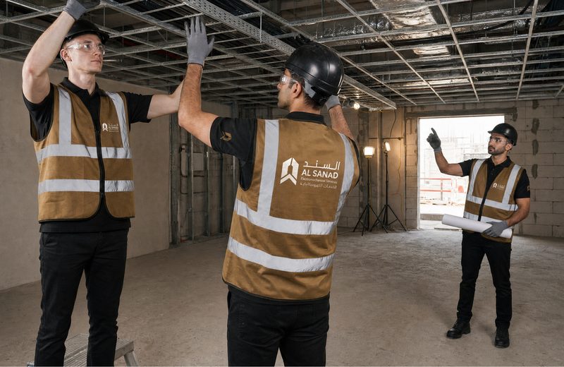 Al Sanad crew installing cable containment on a UAE fit-out